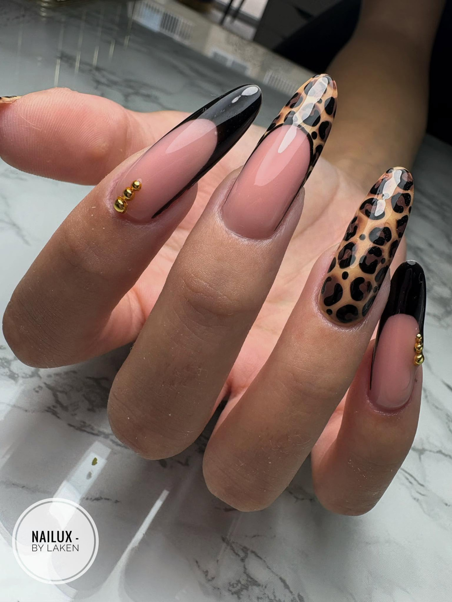 Leopard print French manicure with gold accents by NAILUX nail salon Żebbuġ